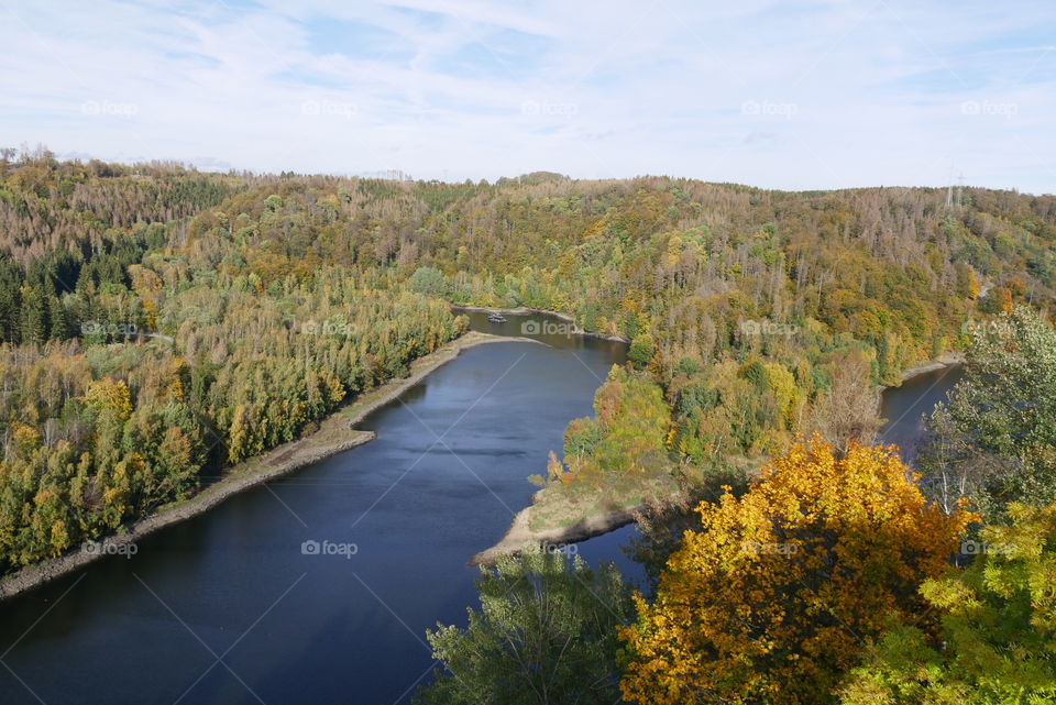 View from a suspension bridge on a reservoir in autumn 