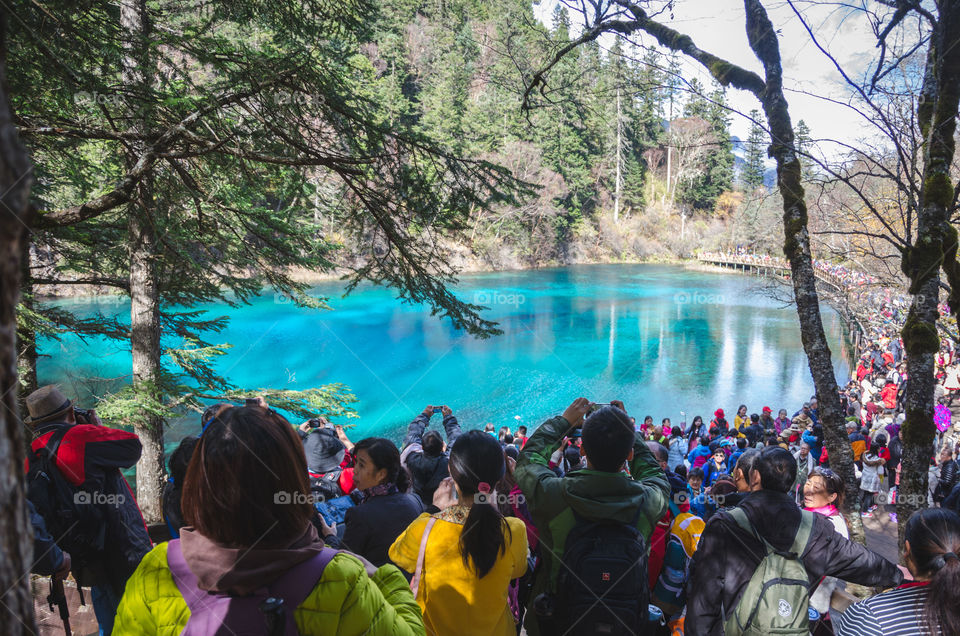 Thousands flock to see the beautiful lakes of JiuZhai valley nature reserve in Sichuan, china.