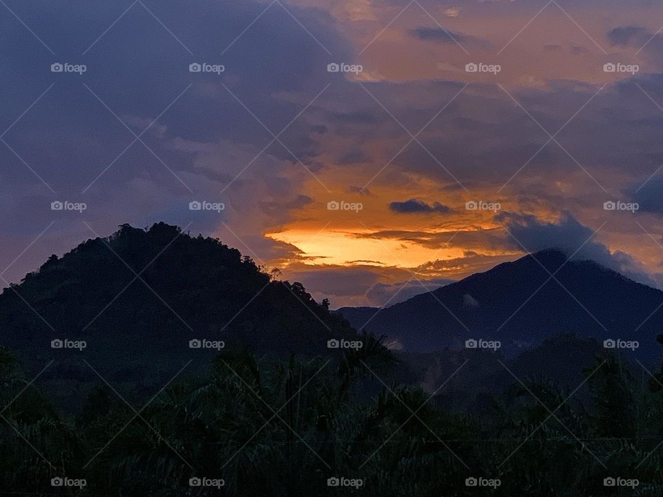 Sunset view between two hills.