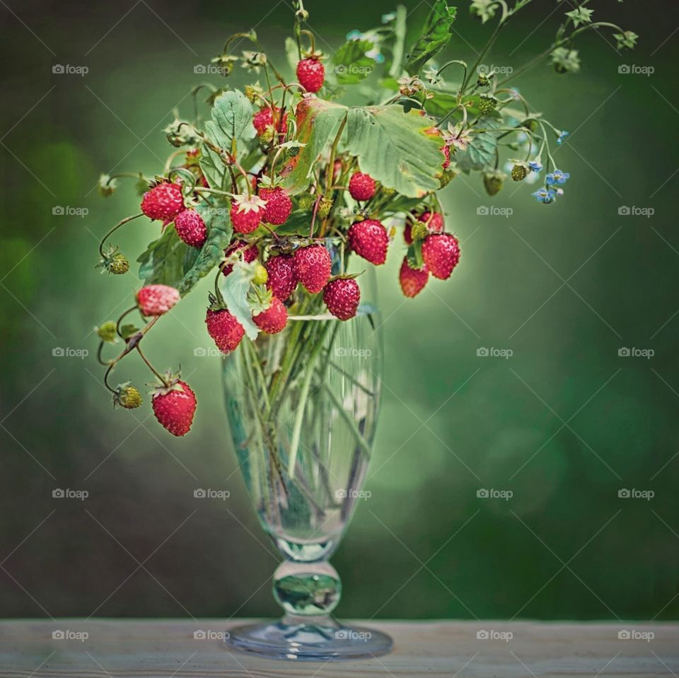 Forest strawberries bouquet in glass