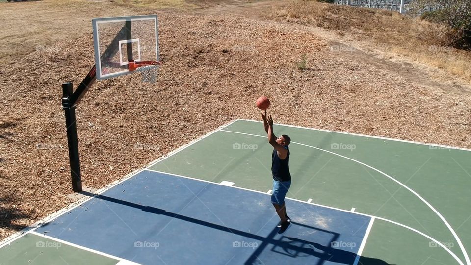 playing basketball on a sunny day in the park