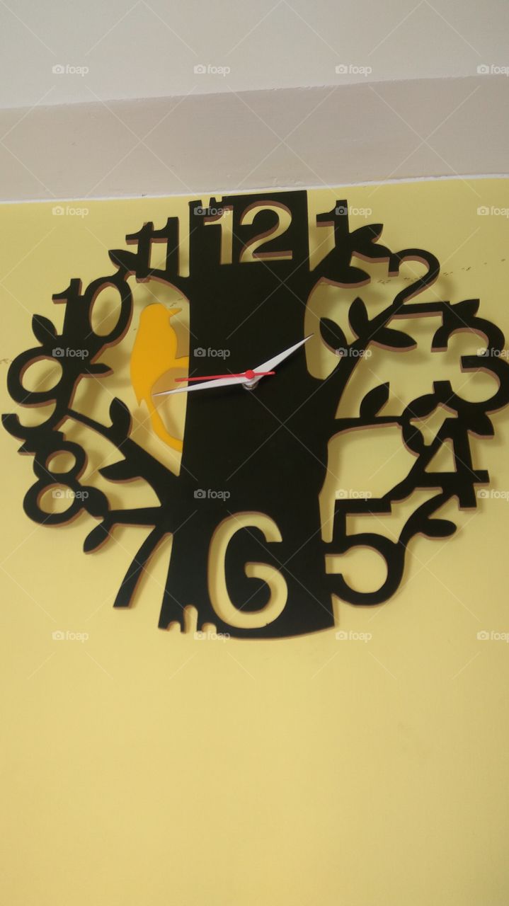 Dark colour clock 
number of display with little bird