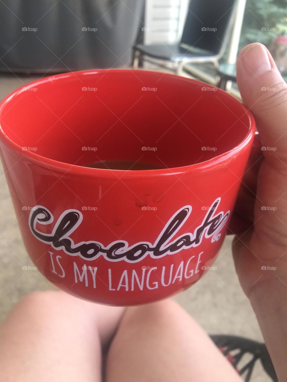 Womens hand holding a big coffee mug