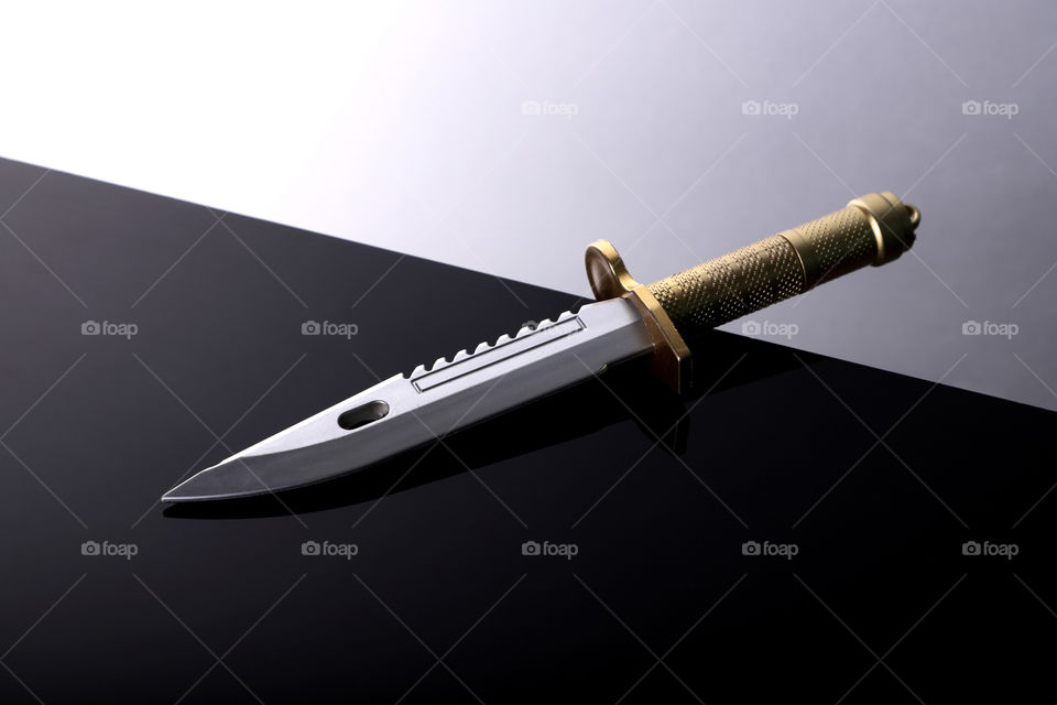 Sharp steel Dagger / knife on black white background