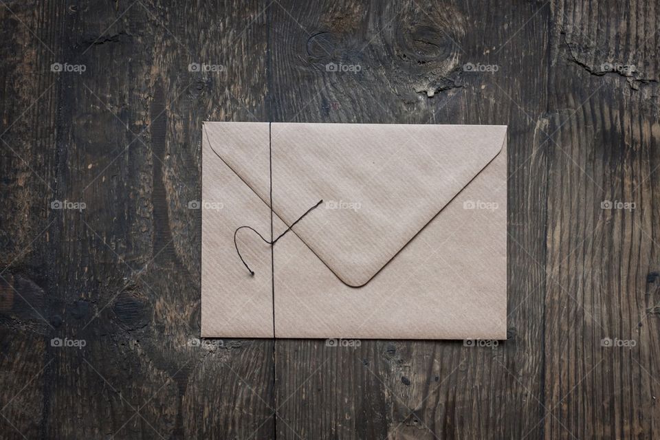 Brown envelope on wood background