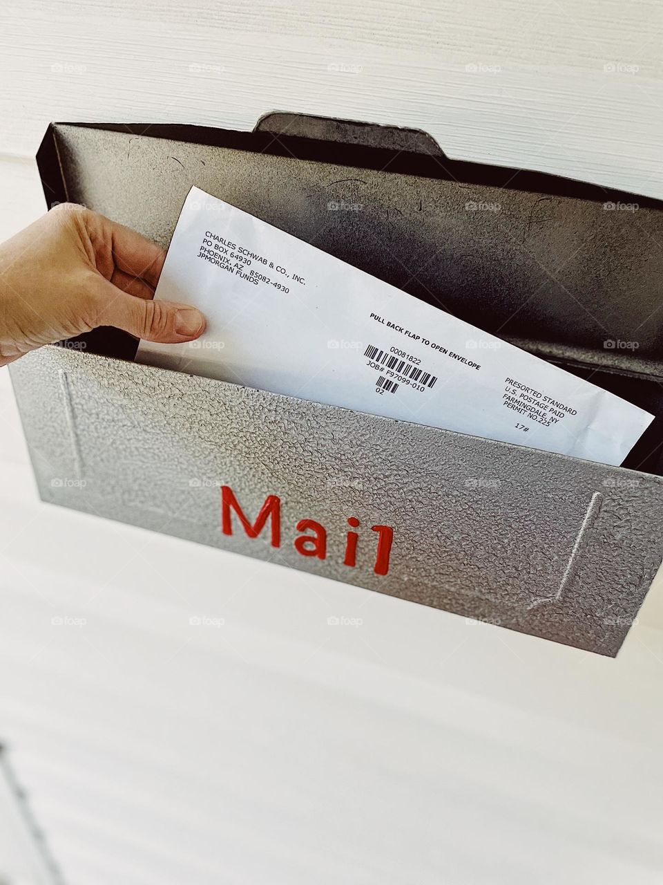 Woman’s hand getting mail from mailbox, receiving mail, daily tasks at home, woman gets mail from mailbox, hand reaching for mail, doing daily tasks 