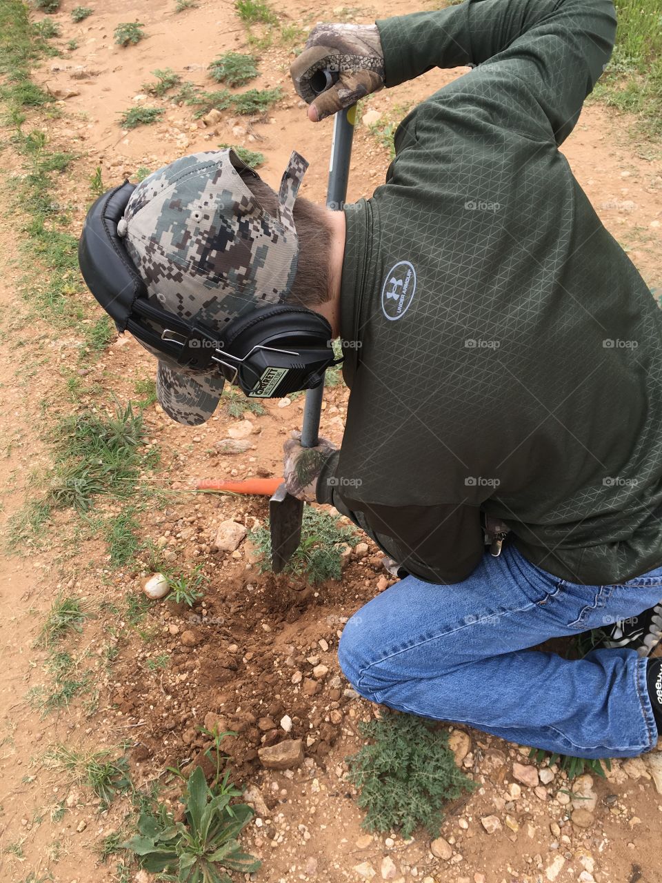 Metal detecting a Texas ghost town.  My son is about to unearth an old harmonica reed.