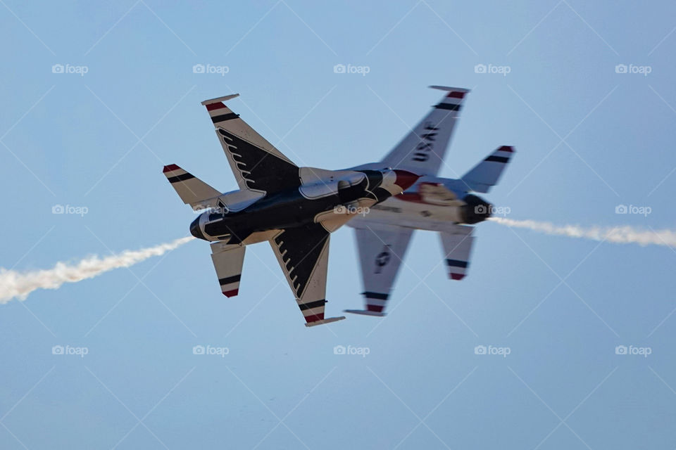 The US Air Force Thunderbirds F-16 jets pass very closely with each other