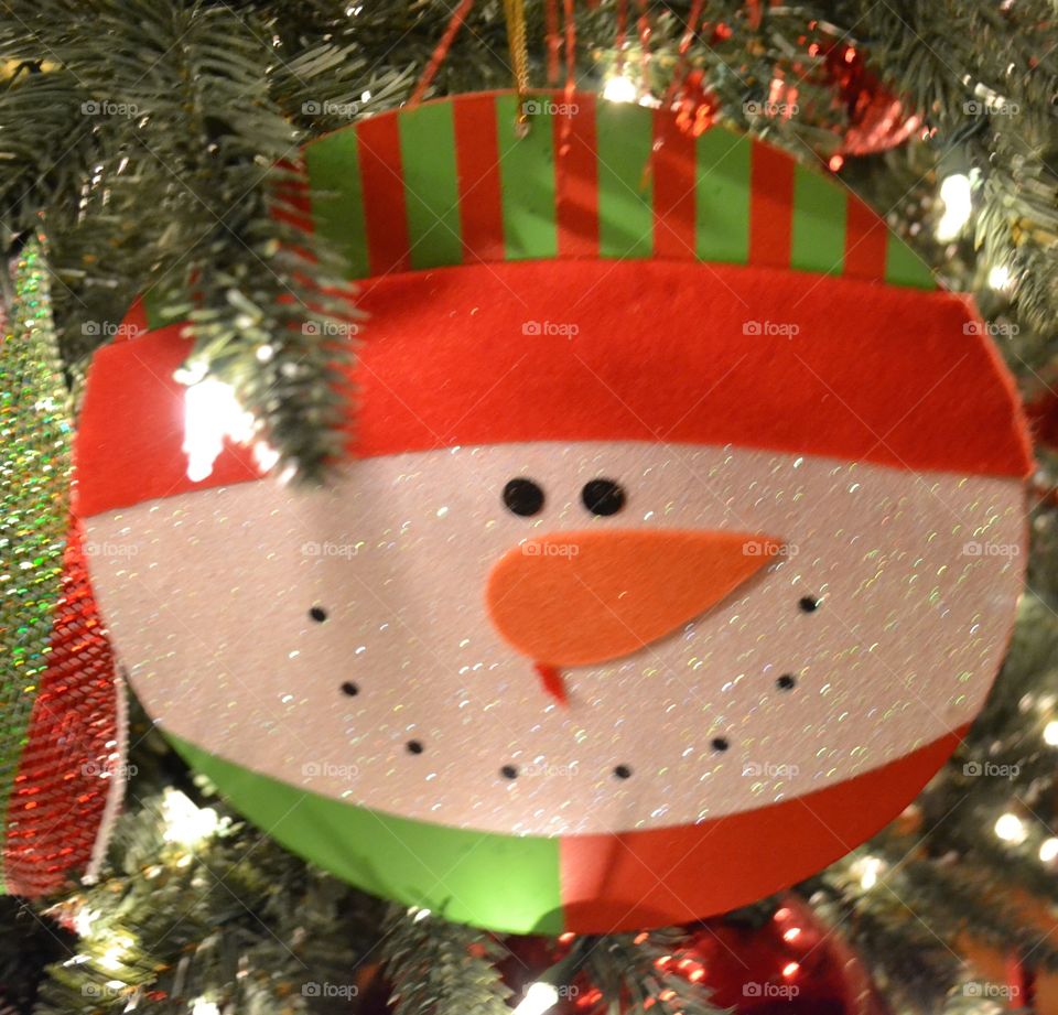 Snowman glistening in the Christmas Tree