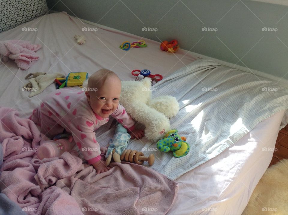 Cute baby girl with Down syndrome smiling