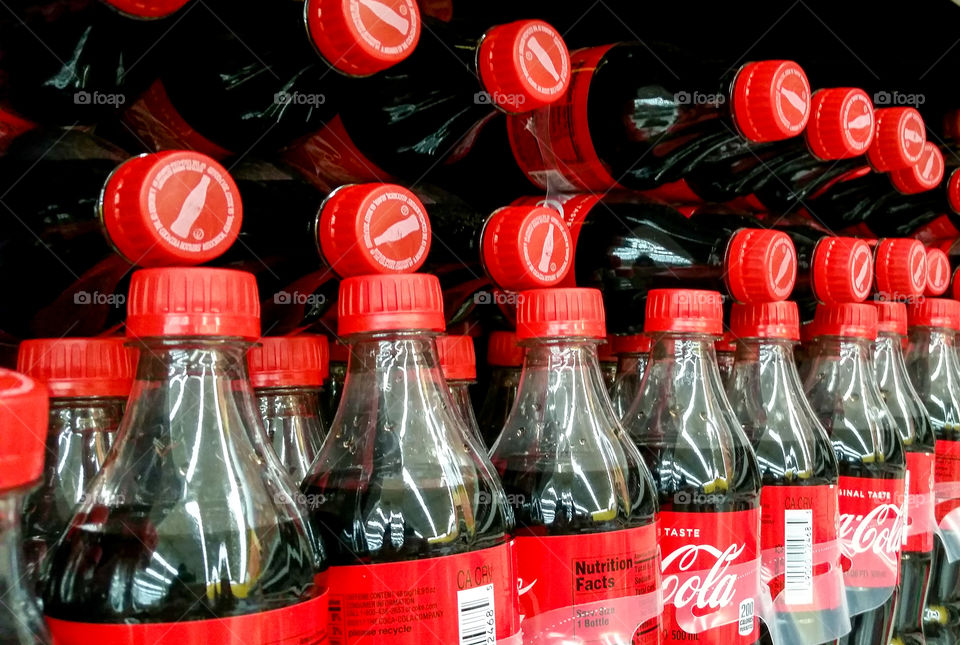 Coca-Cola bottles on a shelf