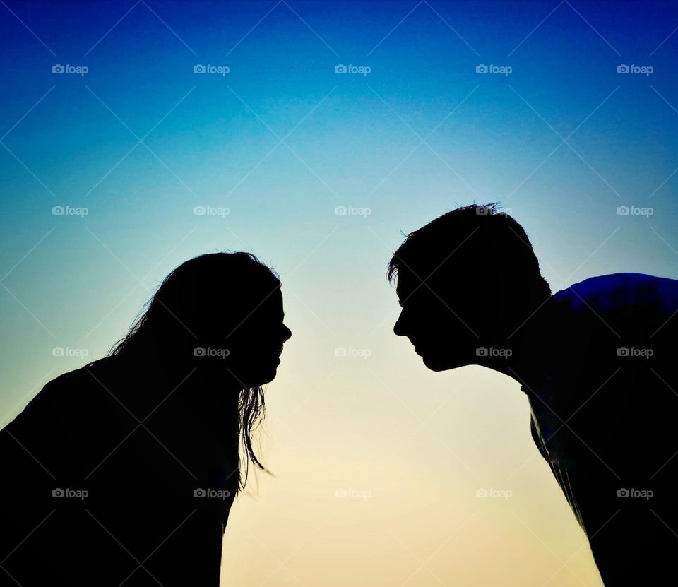 Silhouete of a man and a woman face to face