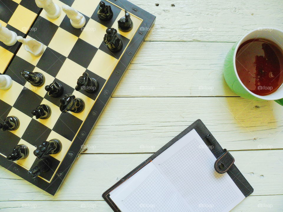 chess, a cup of tea and a notebook