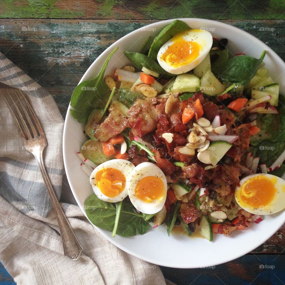 Bacon and Egg Salad. Fresh Spinach Salad with bacon, soft boiled eggs, veggies and mustard dressing 