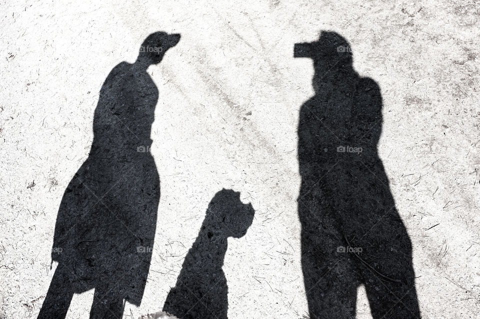silhouettes of two people and a dog