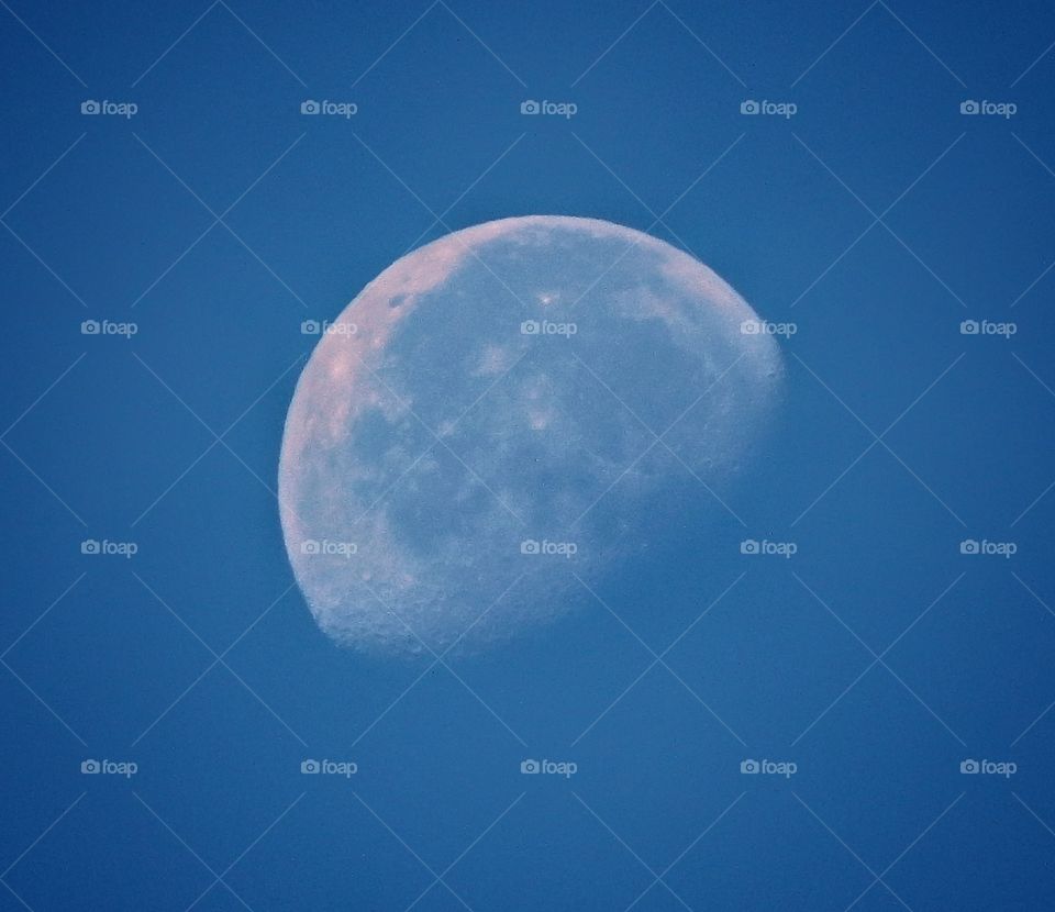 daytime moon in clear blue sky