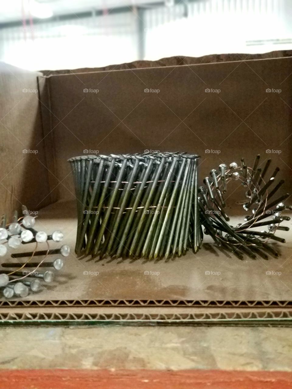 Roll of nails in a box.