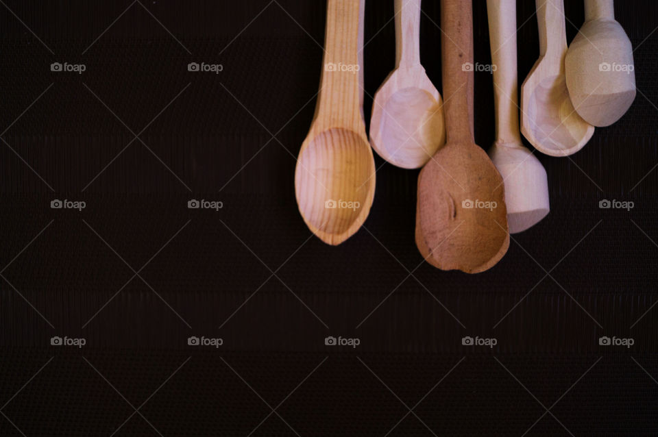 wood ruatic handmade spoons in a black background
