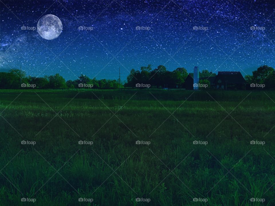 Moon over a small farm and field