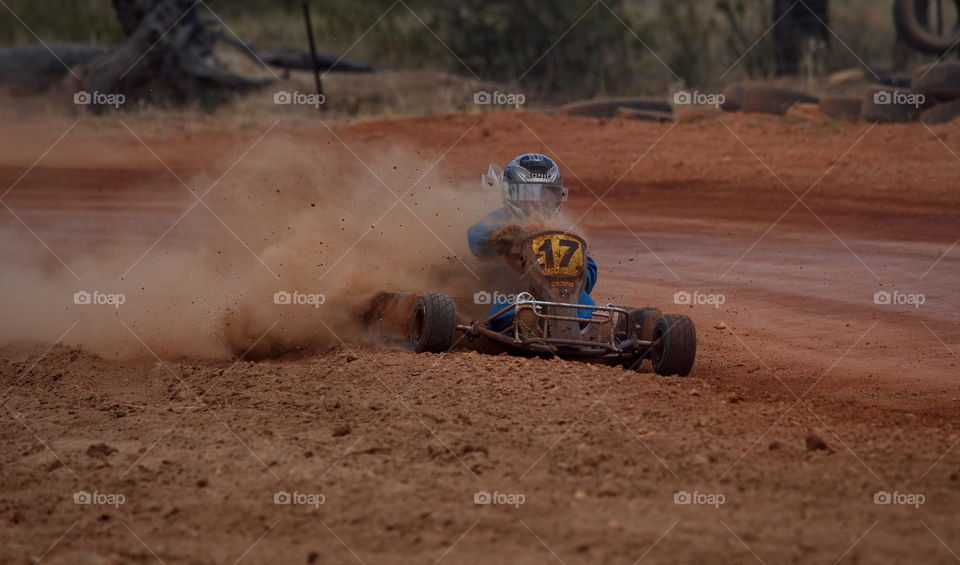 Go kart out of control with dirt flying in all directions