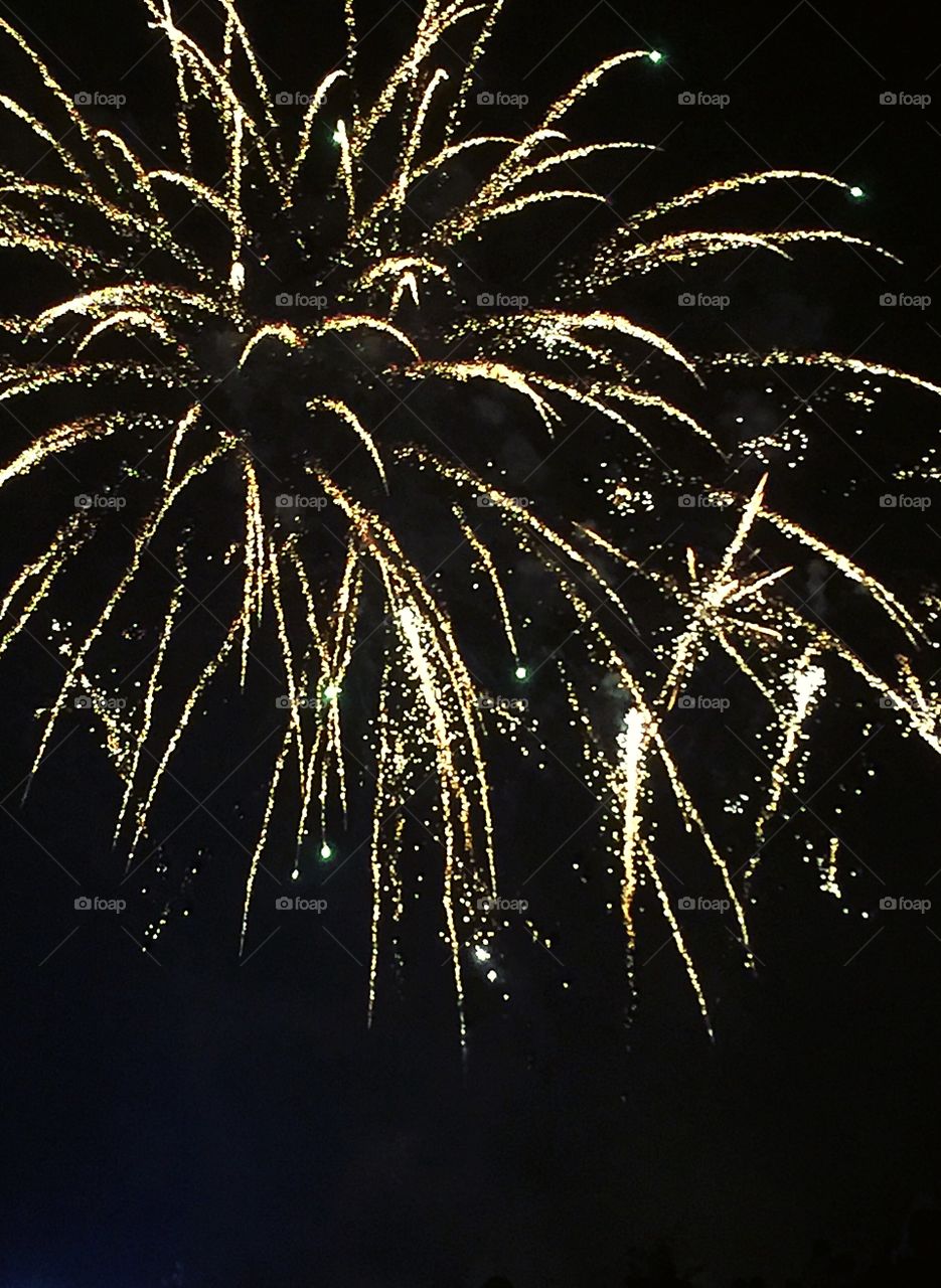Fireworks spreading through the night sky on bonfire night in thousand of sparkling lights. 