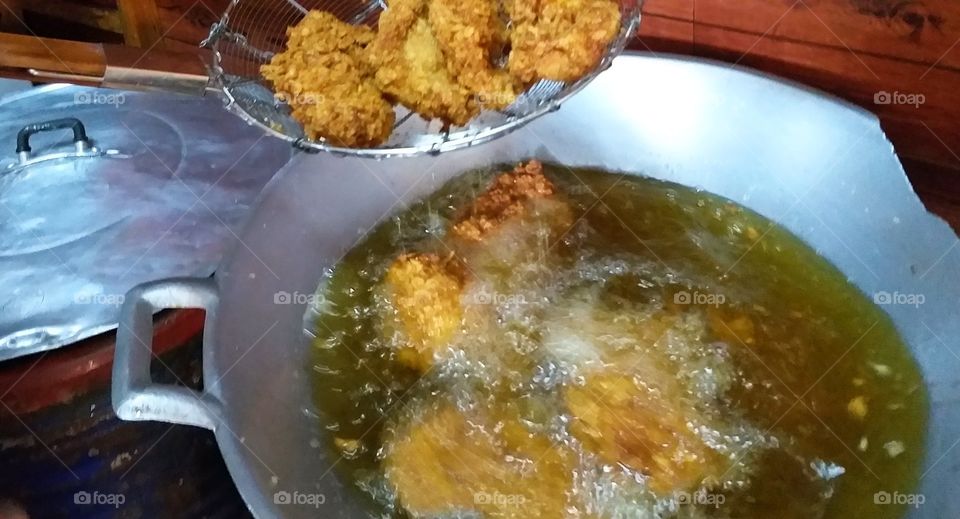 fried chicken in large pan.