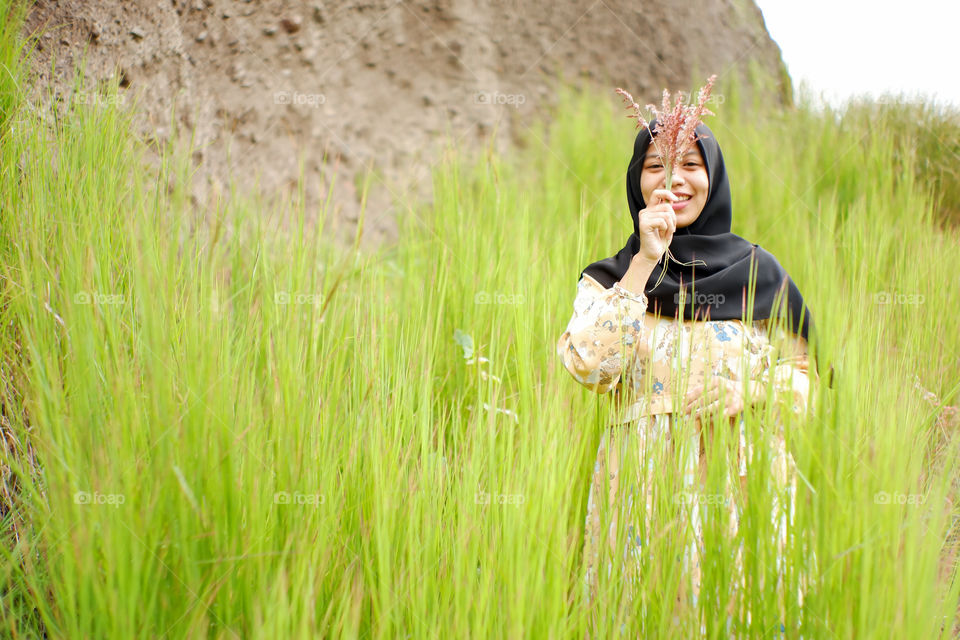 beautiful woman with a cheerful smile expression.  portrait of an asian woman among the bush