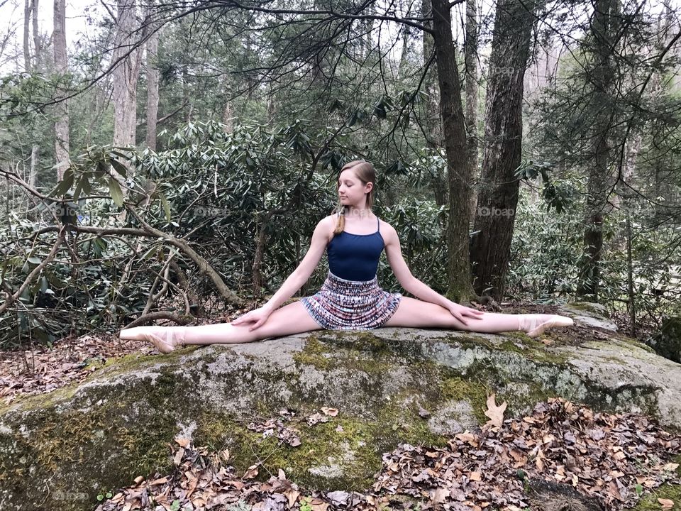 Teenage girl exercising in forest