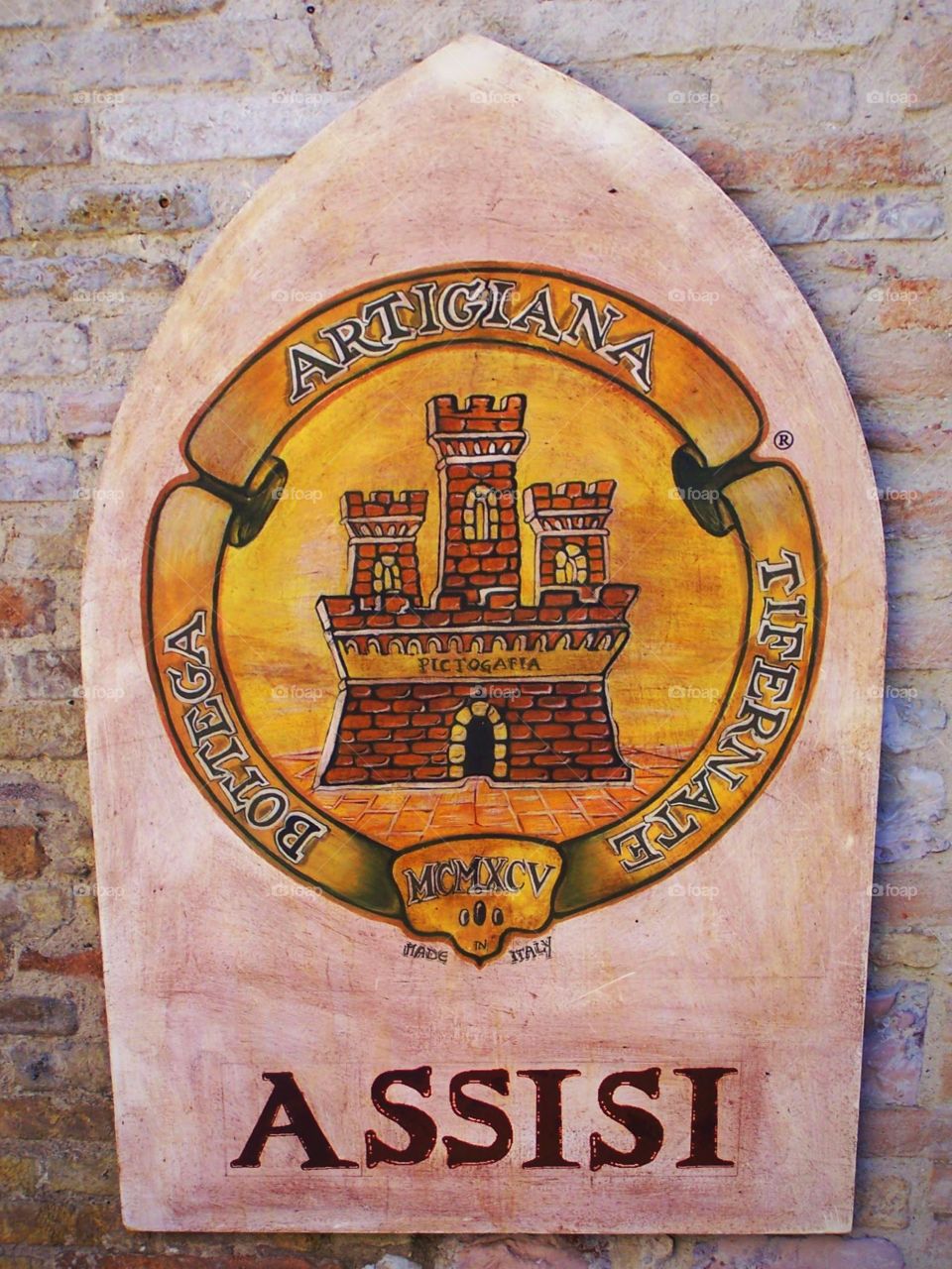 Aged medieval street sign in the village of Assisi in Italy near the cathedral of Saint Francis