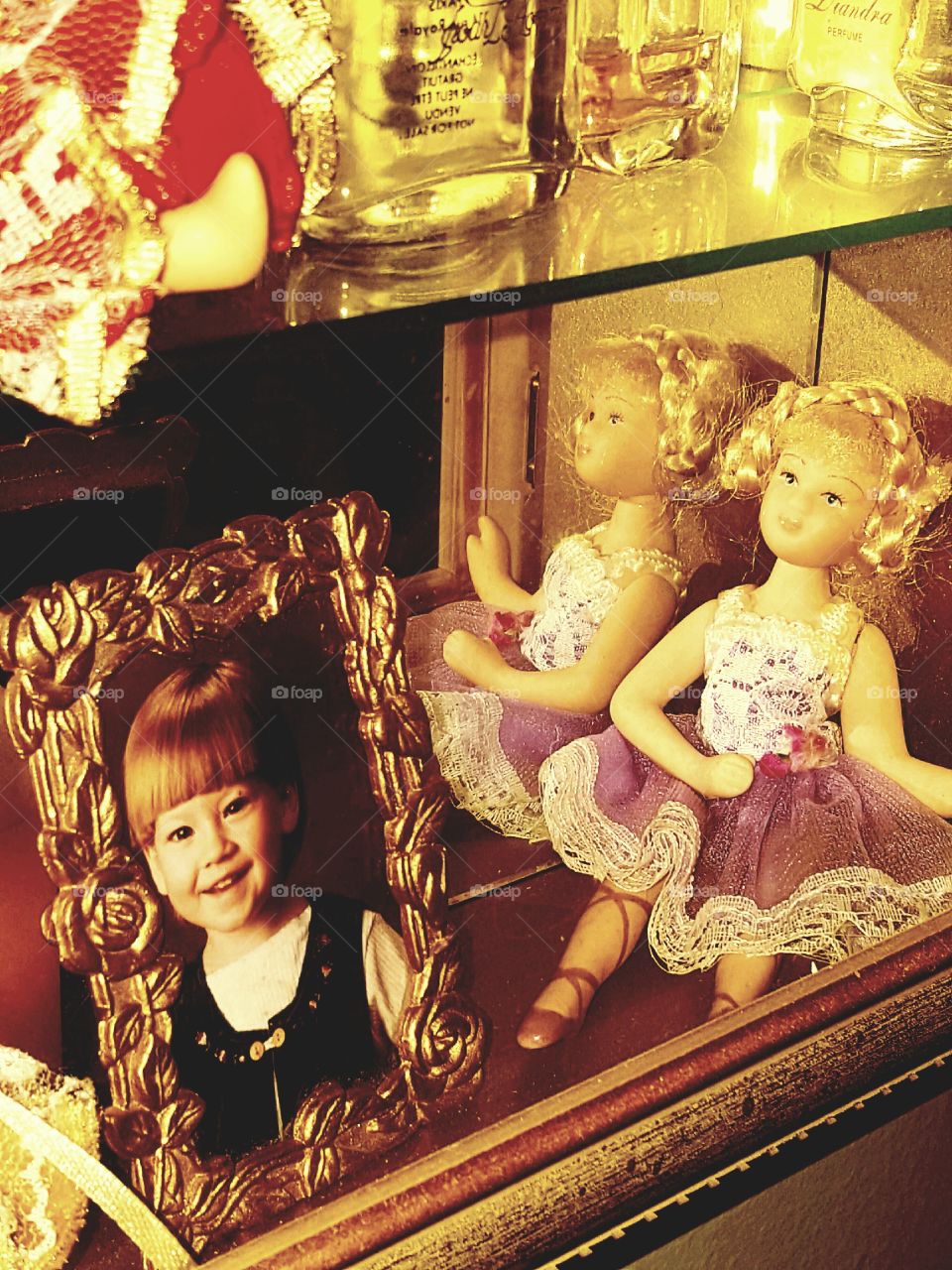 My younger sister has been collecting odds and ends since she first saw our mom's shadow box as a toddler. This mirrored miniature cabinet housing her dolls, jars and photo is just one of those collectibles left over from her earlier days.