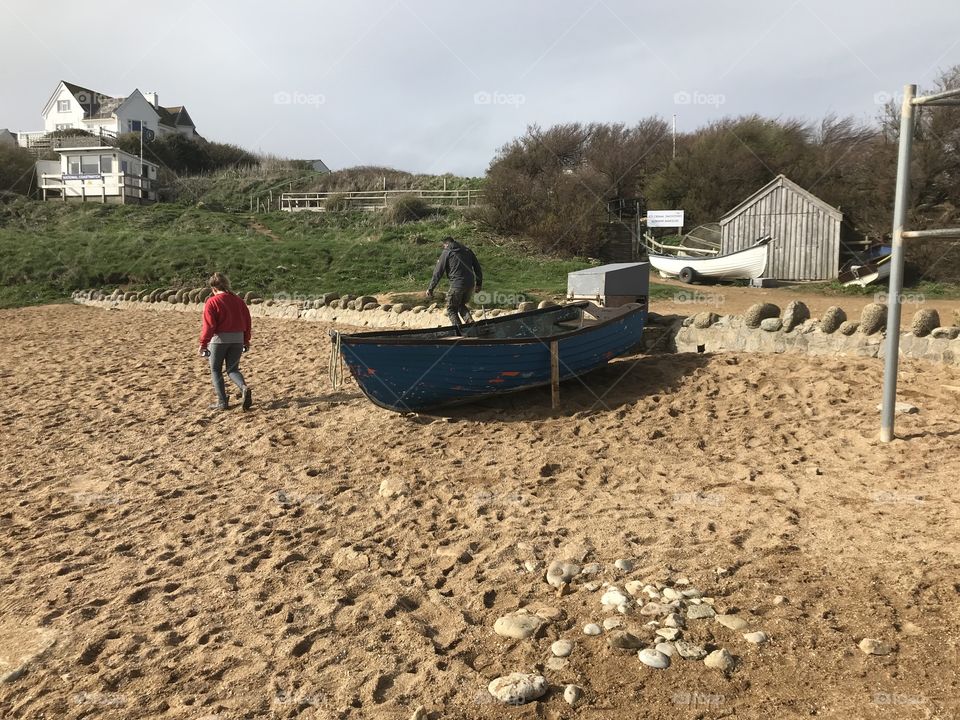 Harbour life on Hive Beach in Dorset,a little sunshine adds to the enjoyment.