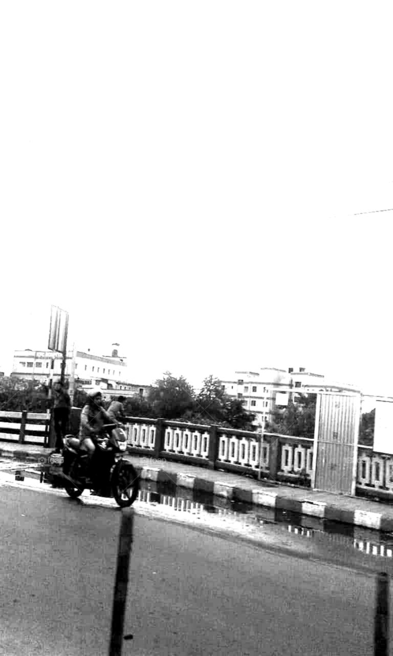 A negative picture of a person Riding a bike. From A to B.