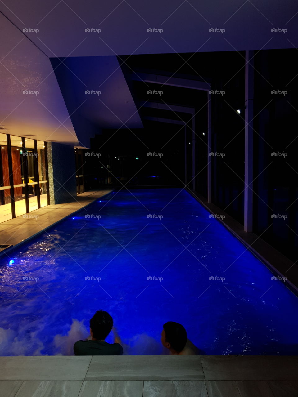 Blue lit indoor pool and spa