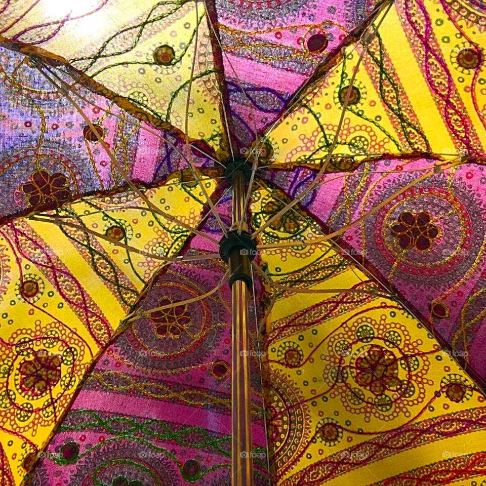 Inside a colorful sun umbrella.