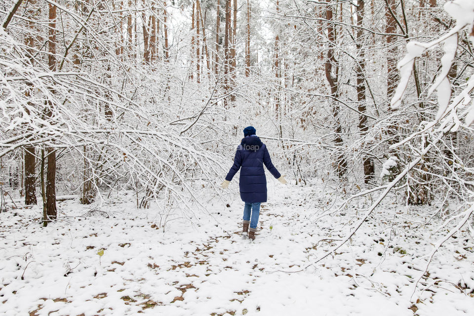 Woman exploring snowy forest