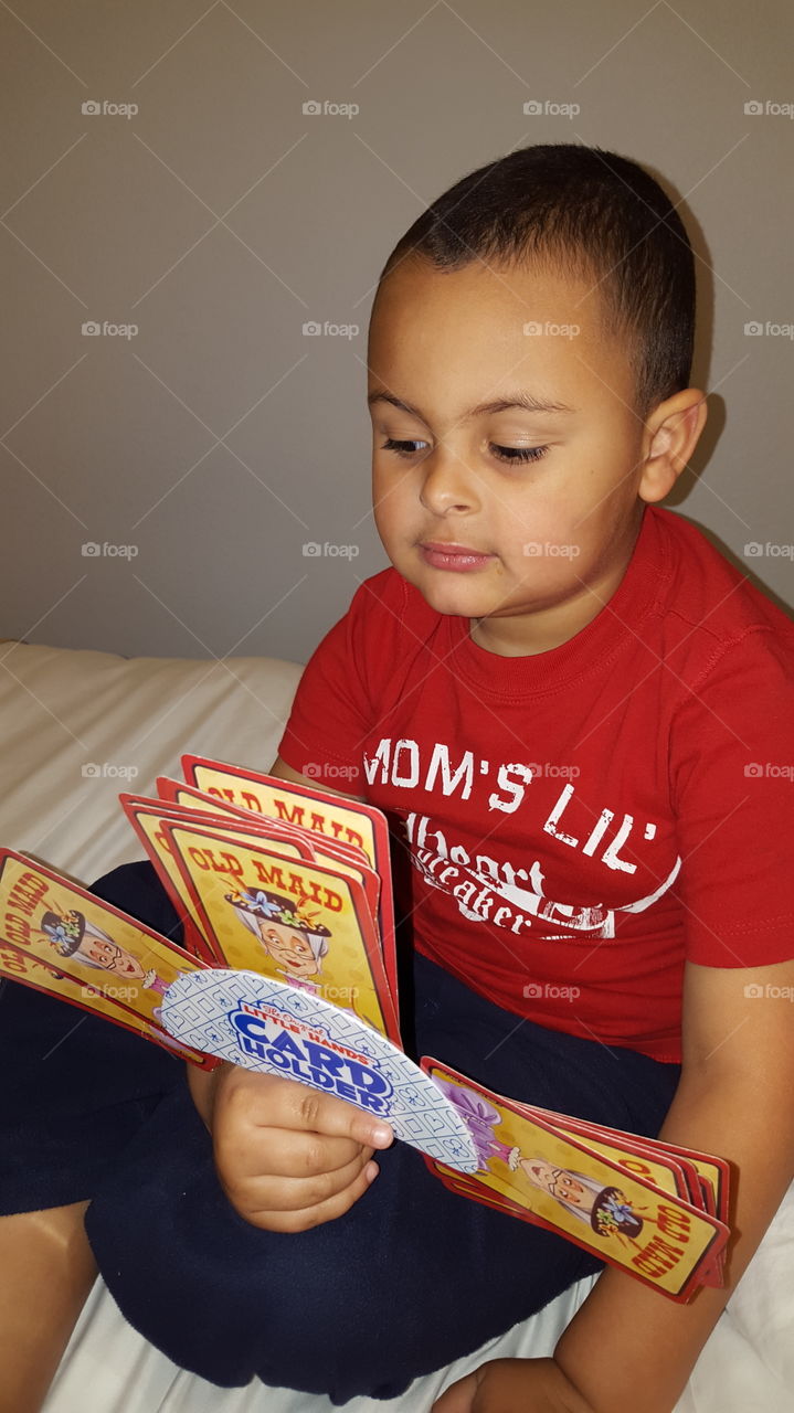 Close-up of a boy playing card