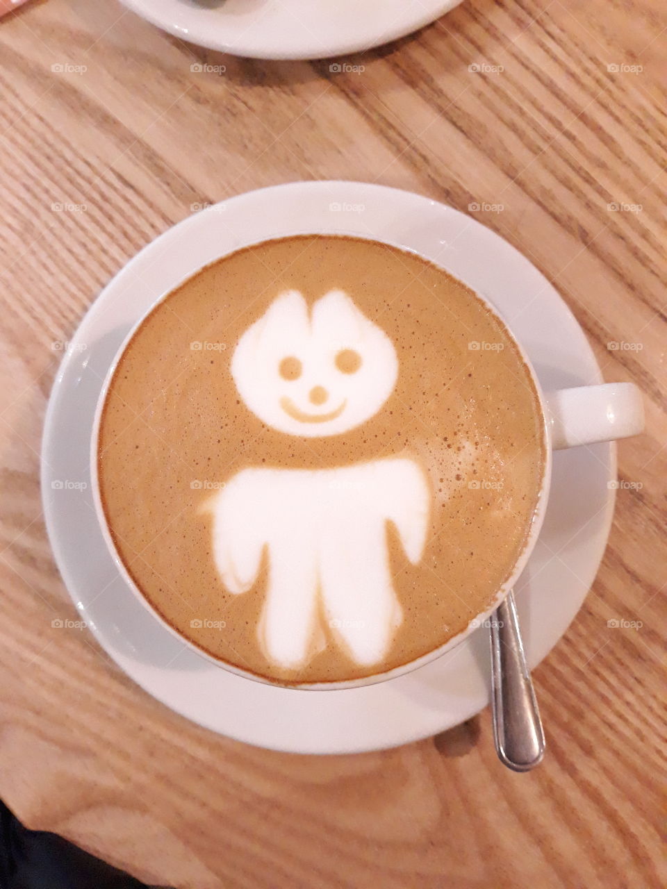 cute coffee froth art with a tiny headless, marshmallow man