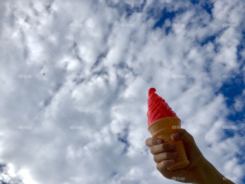 The child is holding a toy ice cream 