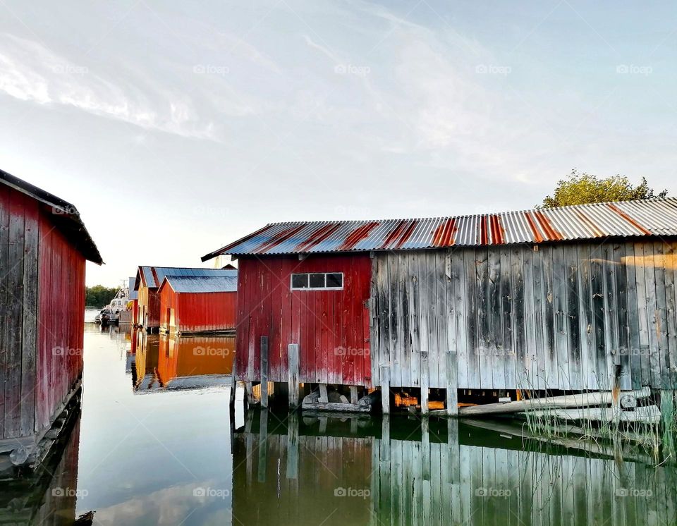 Magnificent old boathouses on a mirror-calm sea