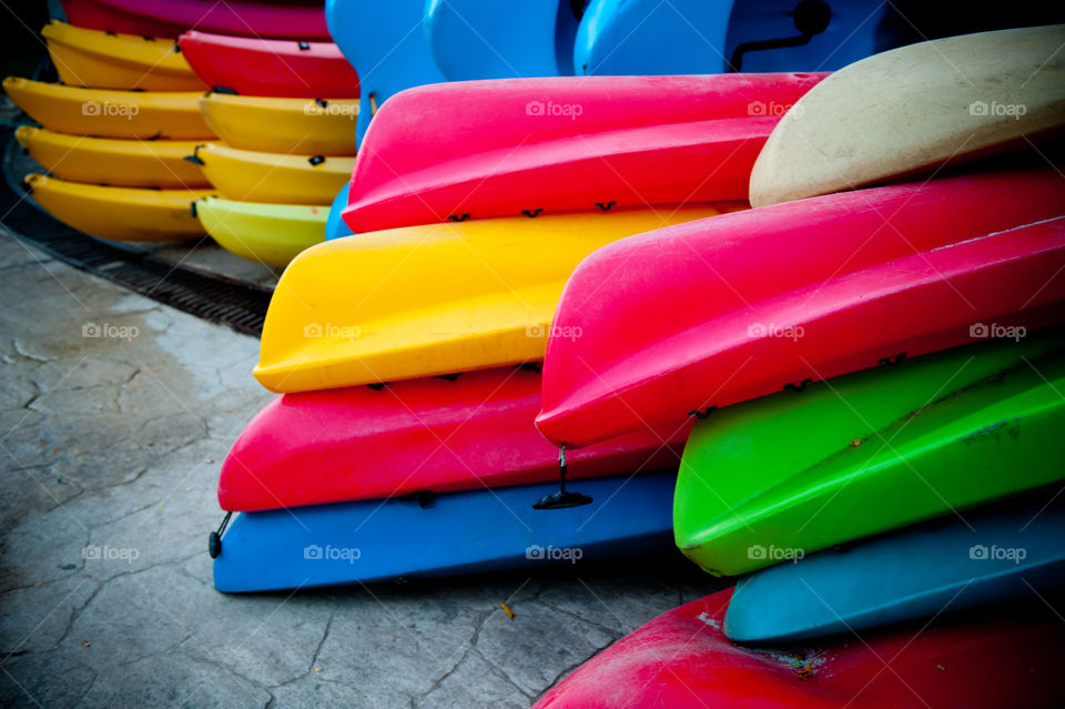 Stack of colorful canoes