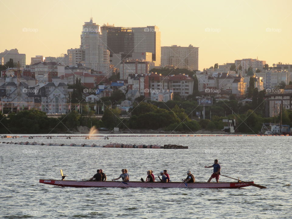 work on the water and rest on the water, kayak with a rower against the background of the city of Voronezh in Russia