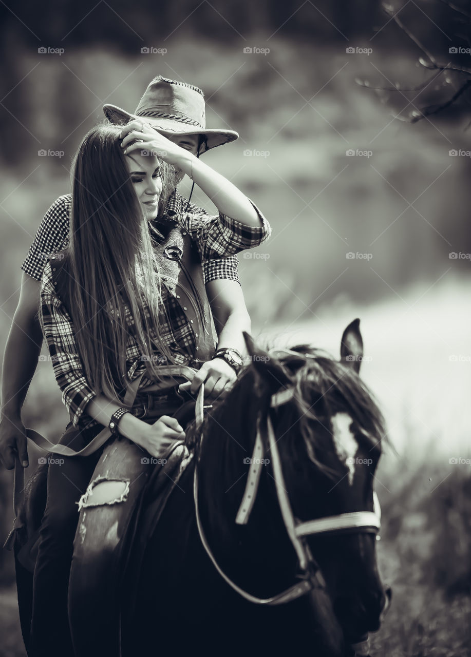 Young couple riding horse