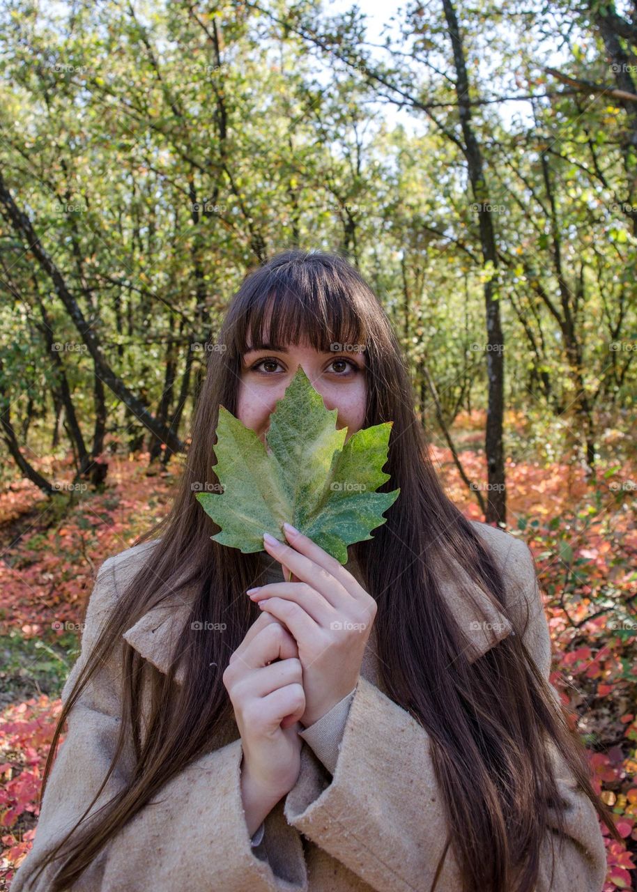 Beautiful Young Girl on Autumn Background