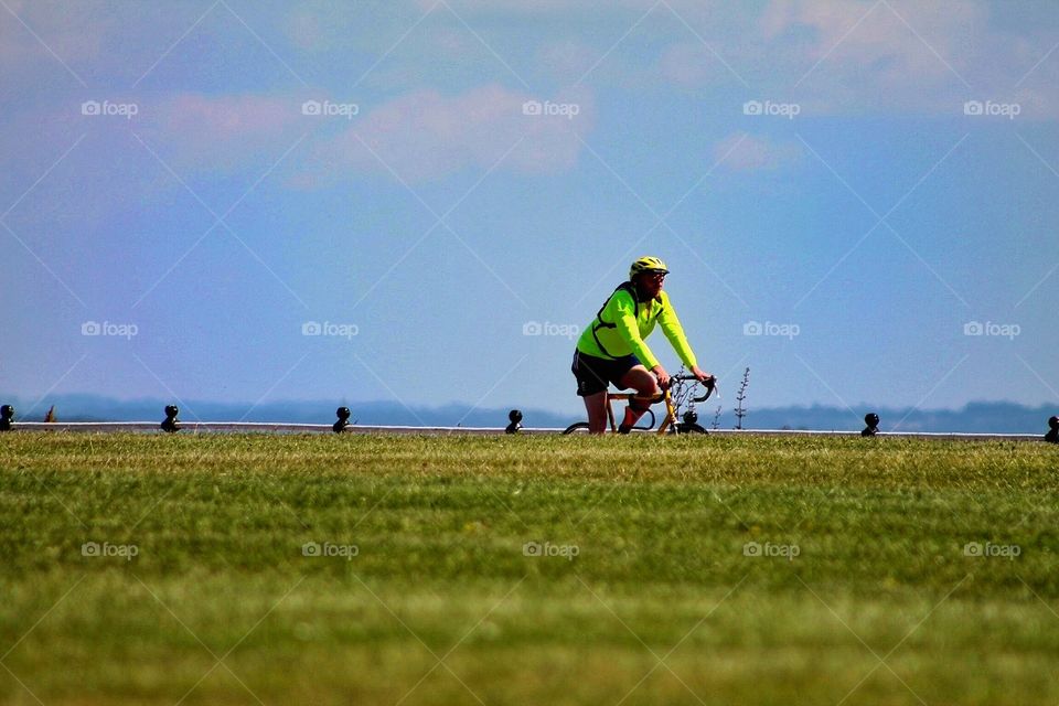 Seaside cycle. Elderly gentleman taking his morning cycle