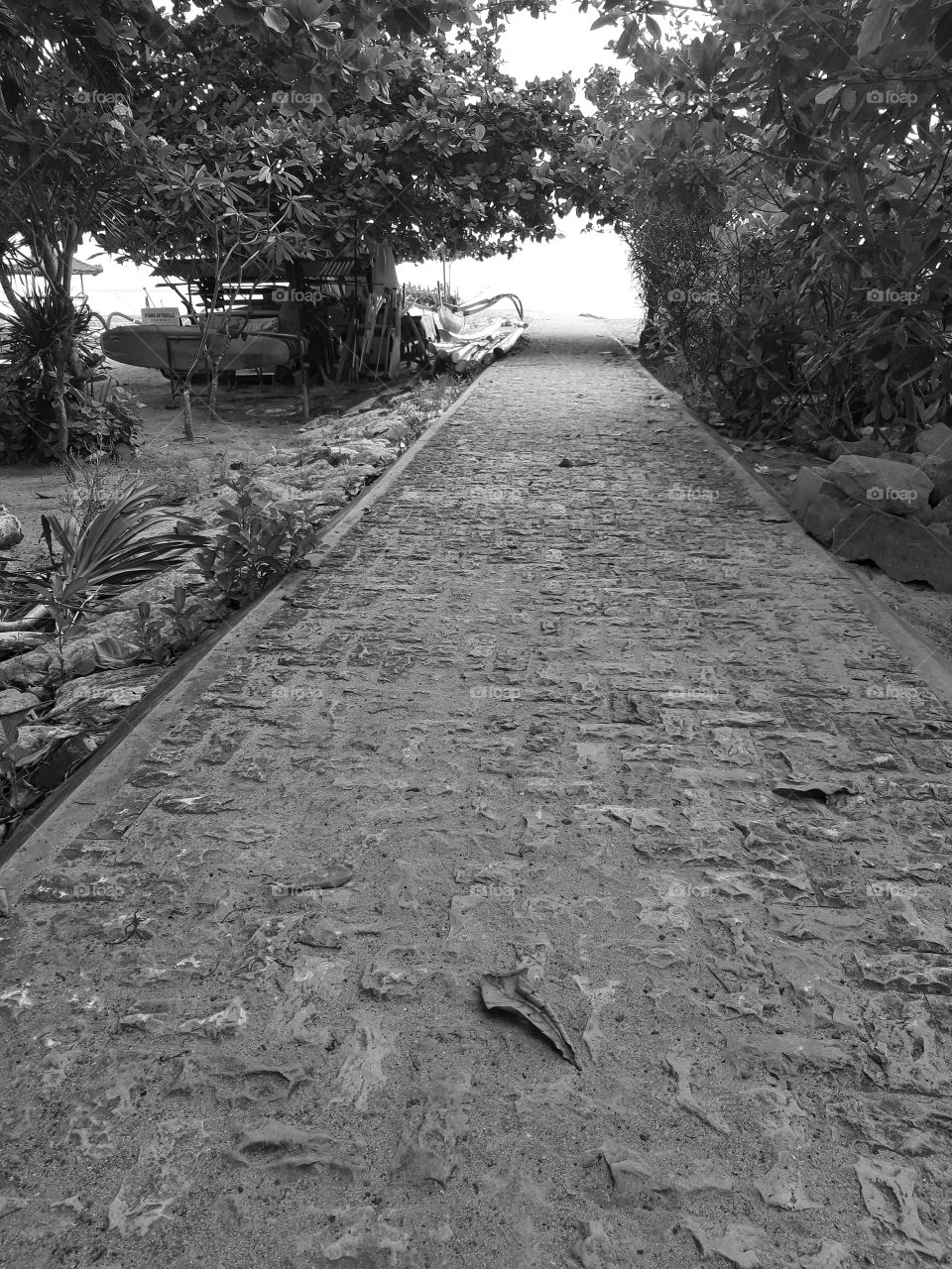 Monochrome style of an empty short straight sidewalk on the beach