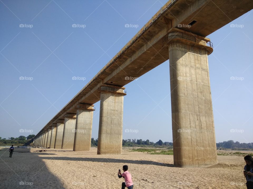 A baby photographer taking photo under the bridge