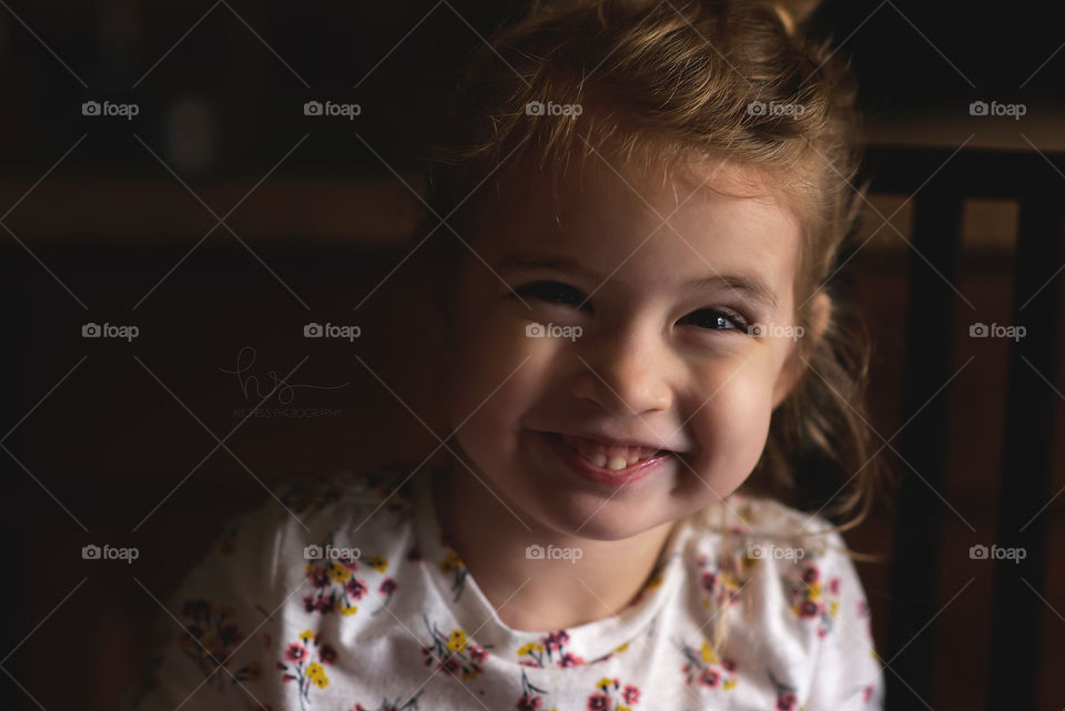 Moody lighting little girl smiling 