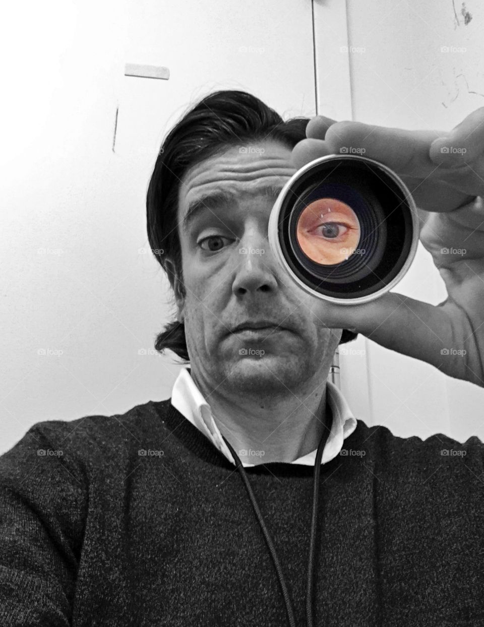 Looking through a cannon lens in black & white with a colored eye