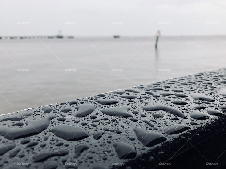  Closeup of water droplets on railing of Bald Head Island Ferry overlooking Cape Fear River, NC