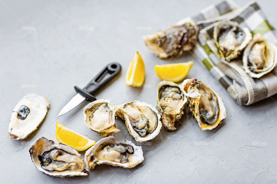 Fresh oysters on gray background 